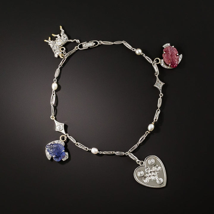 Art Deco Carved Ruby And Sapphire And Diamond Charm Bracelet